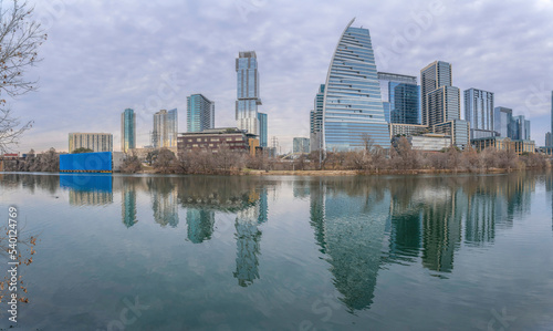 Austin Texas city skyline reflected on the calm pond water against cloudy sky