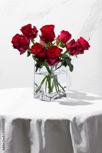 Wallpaper Mural Red roses in a vase on a round table on a white background Torontodigital.ca