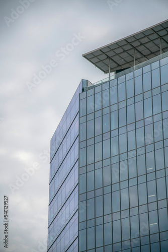 A modern building with glass facade against cloudy sky in Austin Texas