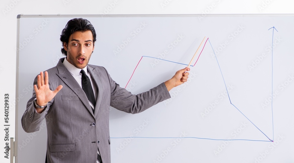 Young handsome businessman in front of whiteboard Young handsome businessman in front of whiteboard