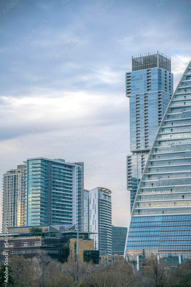 Residential and commercial glass buildings against cloudy sky in Austin Texas.