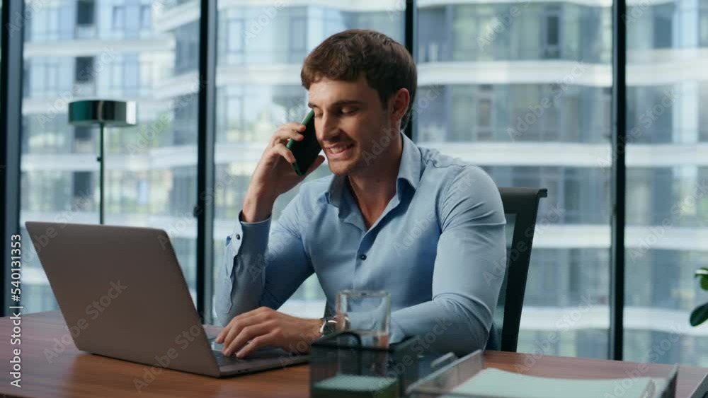 Closeup satisfied person working laptop alone. Manager communicating smartphone Closeup satisfied person working laptop alone. Manager communicating smartphone