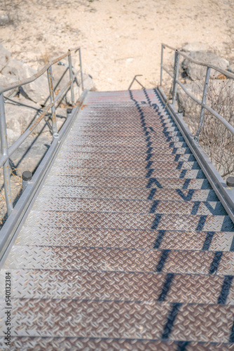 Outdoor staircase against dry sunlit ground near Lake Austin in Texas