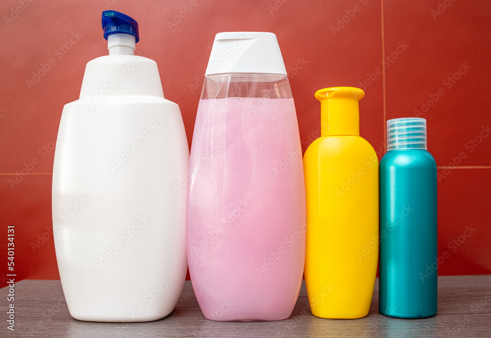 Containers and bottles of different sizes, shapes and colors for cleanser, conditioner, soap and shampoo in the bath. Natural organic cosmetics, packaging with an empty label, branding layout. Containers and bottles of different sizes, shapes and colors for cleanser, conditioner, soap and shampoo in the bath. Natural organic cosmetics, packaging with an empty label, branding layout.