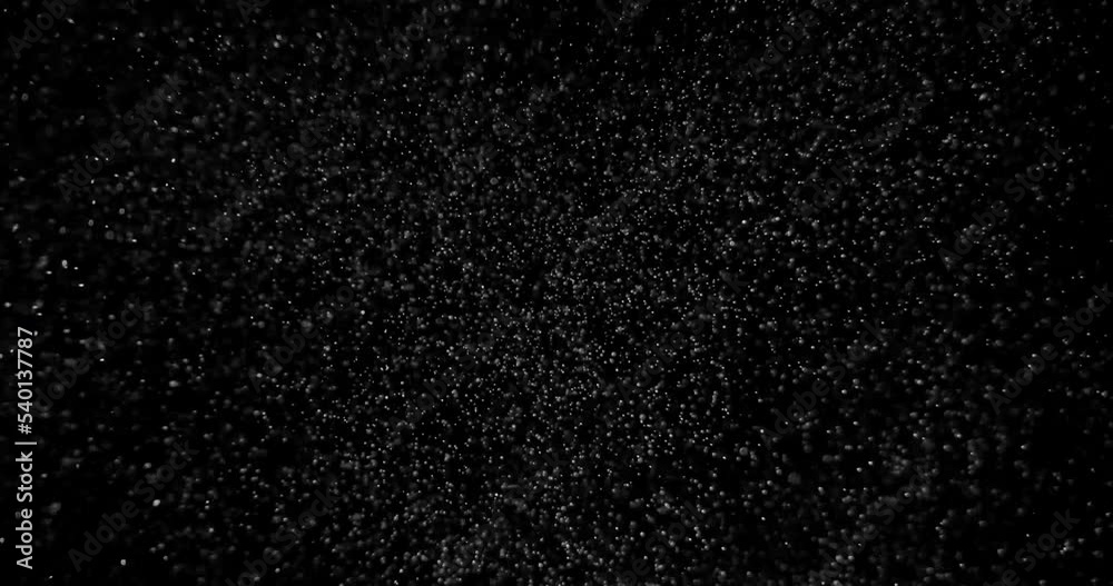 Cinematic snow storm with hard wind on black background in slow motion. Weather atmosphere overlay filmed with RED camera