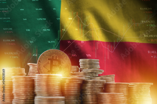 Benin flag and big amount of golden bitcoin coins and trading platform chart. Crypto currency photo