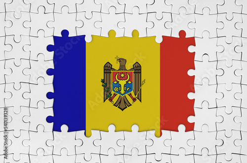 Moldova flag in frame of white puzzle pieces with missing central part