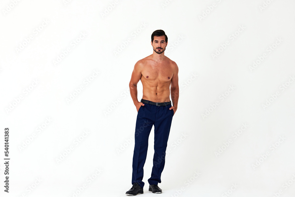 Fototapeta premium Man with bare torso and prue cubes in business pants shows full-length nude body, women's day March 8 on white isolated background copy space