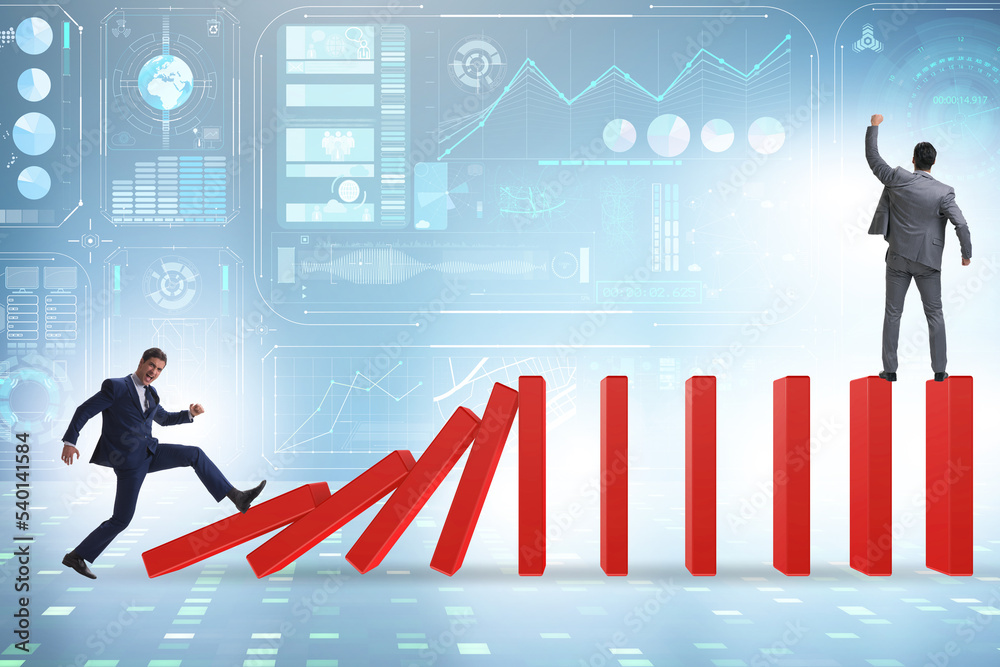 Businessman in domino effect concept Businessman in domino effect concept