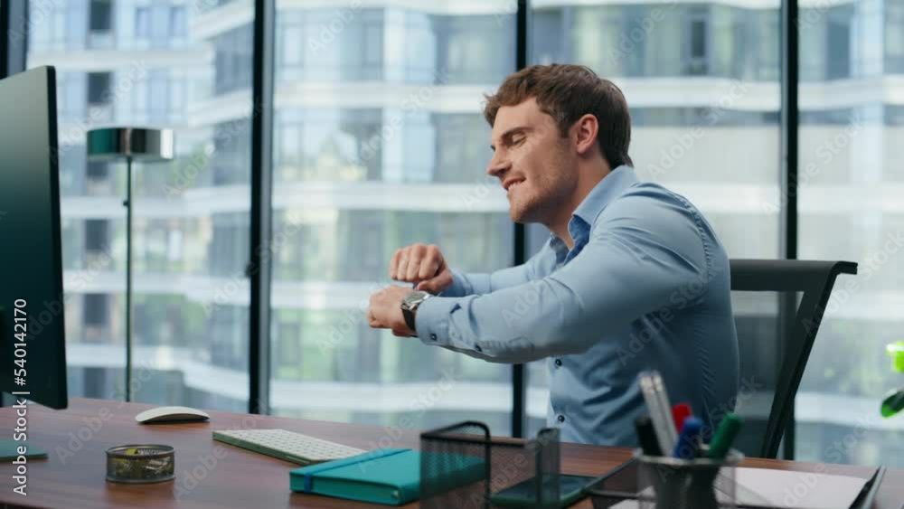 Motivated entrepreneur rejoicing cheering office. Excited director reading news Motivated entrepreneur rejoicing cheering office. Excited director reading news