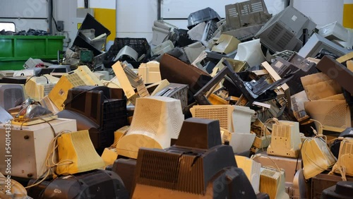 A bunch of old plastic cases from office monitors with kinescopes. A mountain of junk plastic electronics parts for recycling. Dump of technical and electrical equipment.