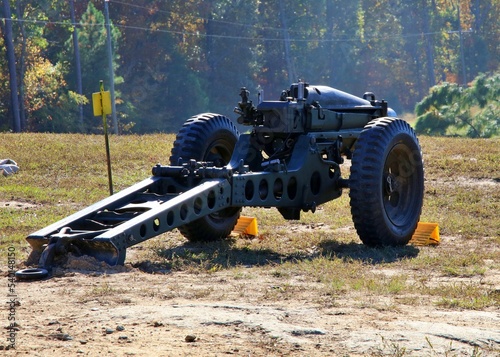 Historic Howitzer cannon over looking a smoke filled field after firing from atop a strategic position on a hill.  