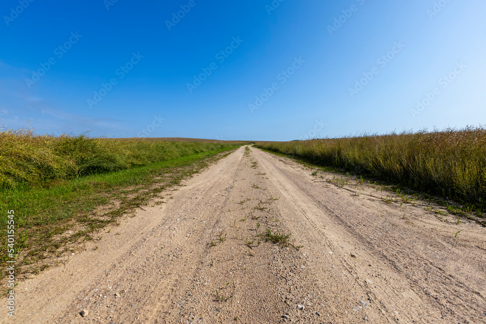 Naklejka premium Gravel highway in rural areas
