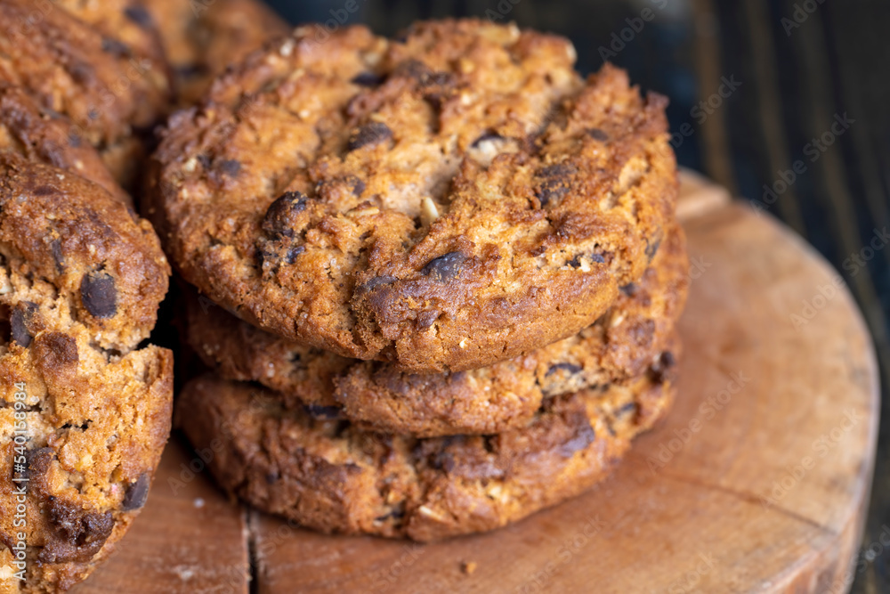 Delicious cookies with pieces of chocolate on the table