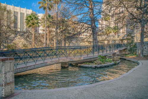 Walkway trail passing over rippling water at San Antonio River Walk in Texas