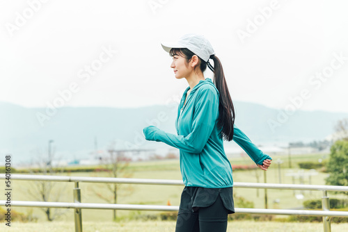 ダイエットのため公園でランニングするスポーツウェアのアジア人女性  © buritora