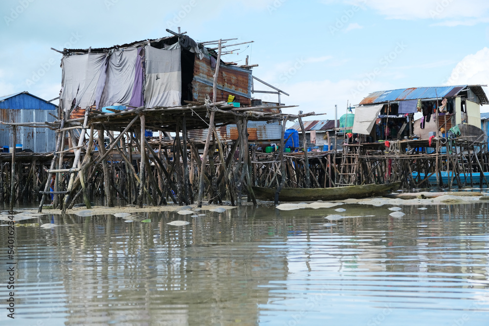 Omadal Island is a Malaysian island located in the Celebes Sea on the state of Sabah. The bajau laut village community during low tide time. Omadal Island is a Malaysian island located in the Celebes Sea on the state of Sabah. The bajau laut village community during low tide time.