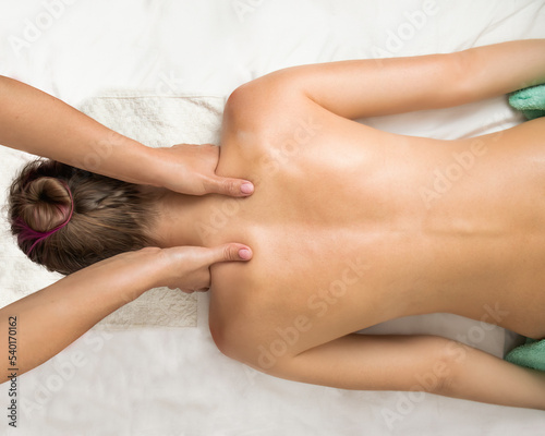 neck zone massage, osteopathic massage, back massage,massage therapist doing back massage close-up,wellness massage