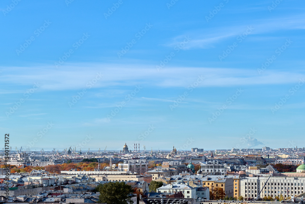 Rooftops of a European city on an autumn day. Cityscape taken from the observation deck. Roofs of houses and buildings, domes of churches and cathedrals taken from a great height.