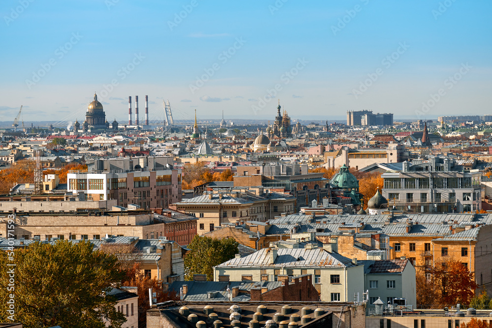 View of the roofs of the old big city from a height. European city on an autumn sunny day.