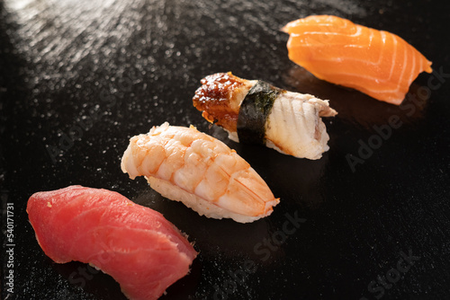 sashimi sushi set on black background, set nigiri on a black. Eel, salmon and tuna sushi