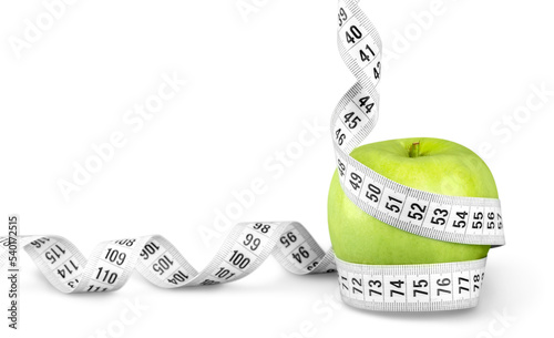 Body Measuring Tape Around A Green Apple