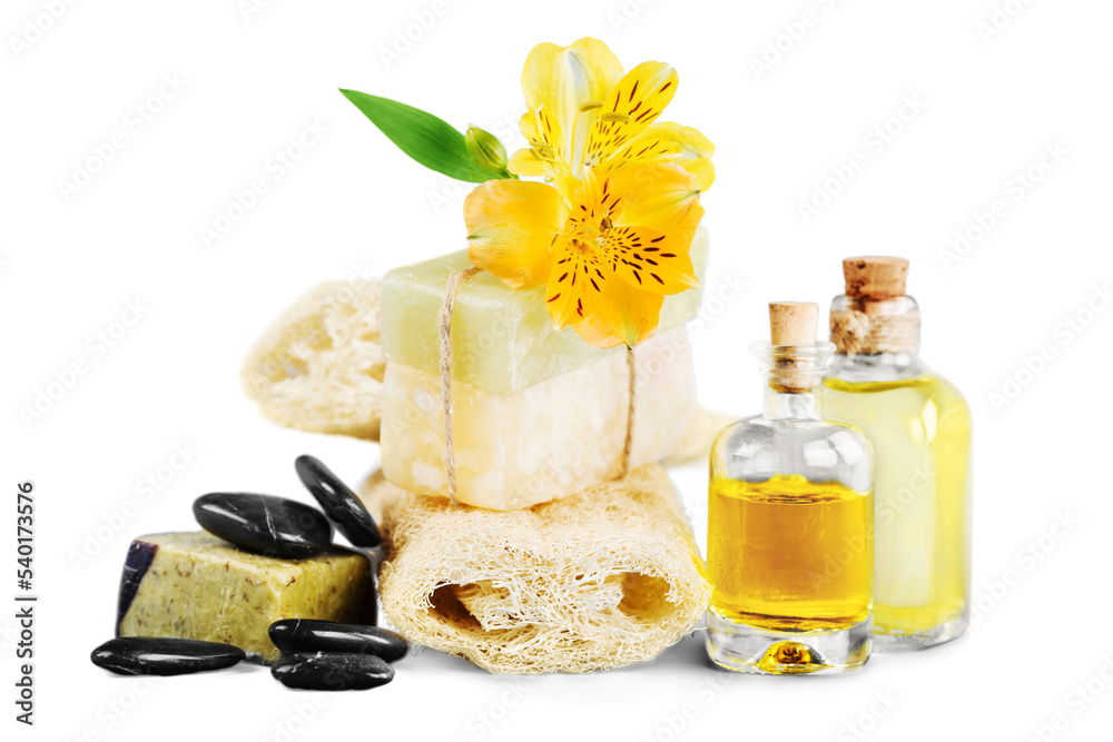 Healthy spa concept with handmade soap bars, oil bottles, sponge and flowers Healthy spa concept with handmade soap bars, oil bottles, sponge and flowers