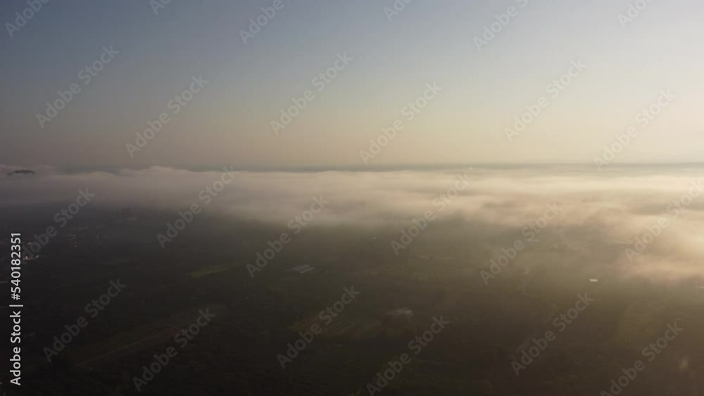 Aerial view of sky and sunlight during beautiful sunrise with clouds and fog in the morning. Natural sky background in the early morning in the mountains Aerial view of sky and sunlight during beautiful sunrise with clouds and fog in the morning. Natural sky background in the early morning in the mountains