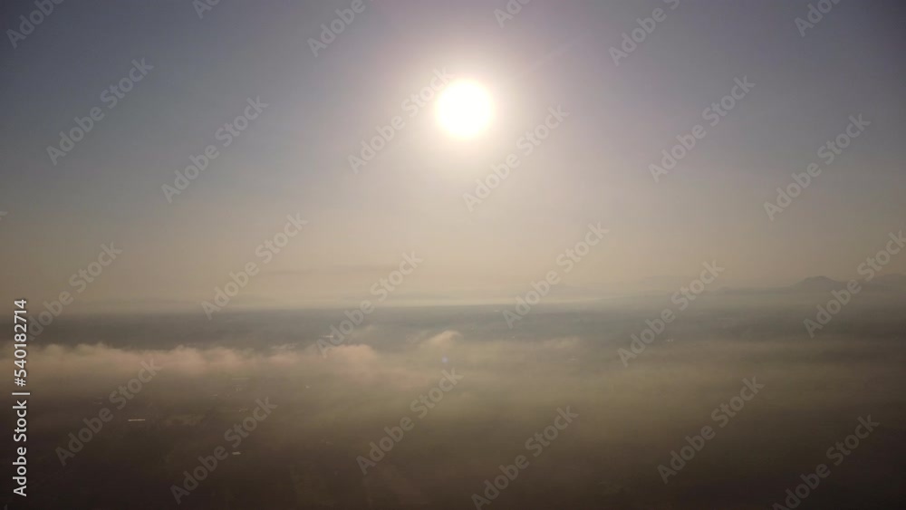 Aerial view of sky and sunlight during beautiful sunrise with clouds and fog in the morning. Natural sky background in the early morning in the mountains Aerial view of sky and sunlight during beautiful sunrise with clouds and fog in the morning. Natural sky background in the early morning in the mountains