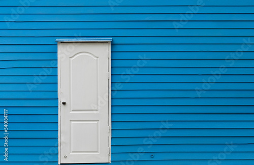 Full Frame of White Door Ageist Blue Plank Wall photo