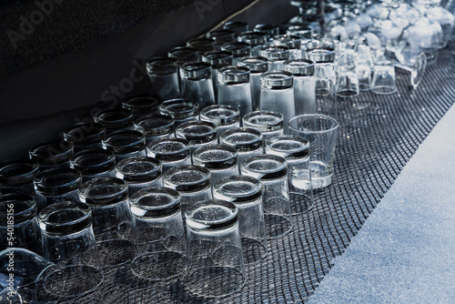 Clean and empty upside down beverage glasses arrangement in restaurant