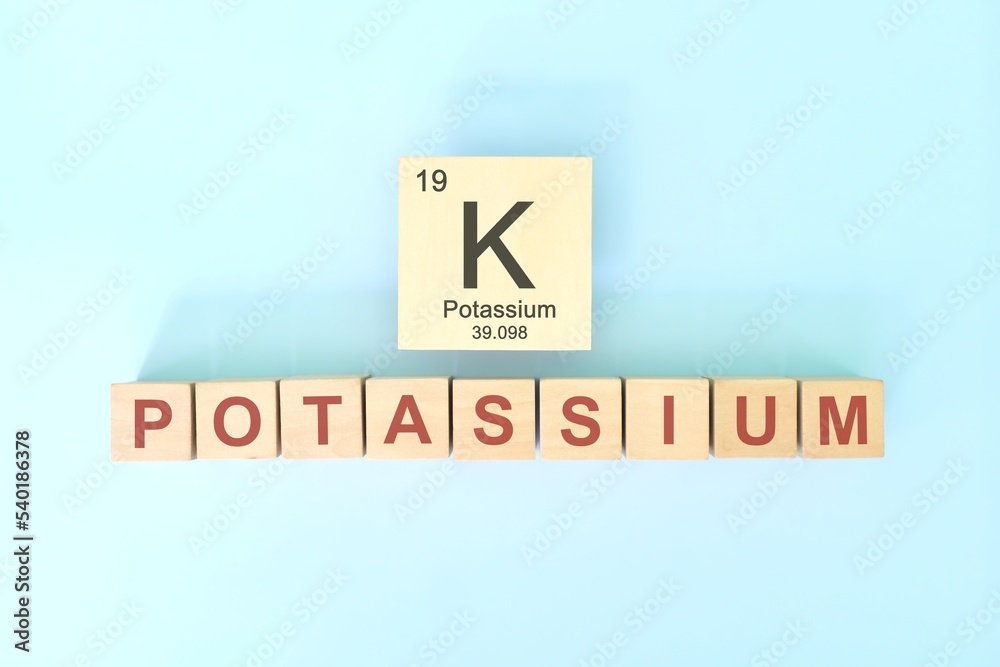 Potassium chemical element symbol with atomic mass and atomic number in wooden blocks flat lay composition. Chemistry and Science concept.
