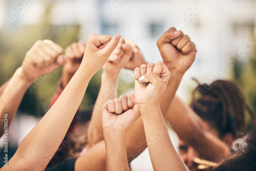 Hands, protest and community with a group of people fighting for change or human rights in the city. Freedom, collaboration and politics with a crowd standing for climate change or equality outdoor