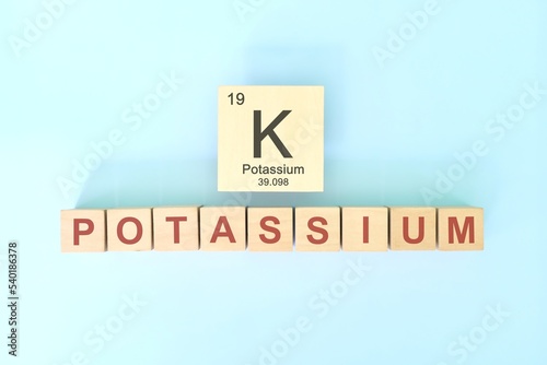 Obraz na płótnie Potassium chemical element symbol with atomic mass and atomic number in wooden blocks flat lay composition. Chemistry and Science concept. w salonie