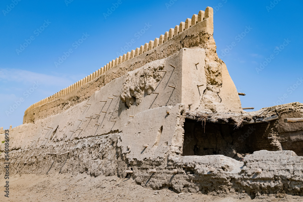 Fragment of a ancient urban defensive wall on a sunny day. Bukhara, Uzbekistan