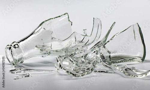 Broken glass bottle. Sharp shards of clear glass.