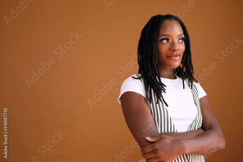 Studio portrait of young beautiful woman with dreads photo