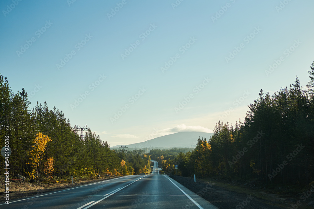 Highway through the autumn forest. Autumn forest highway Highway through the autumn forest. Autumn forest highway