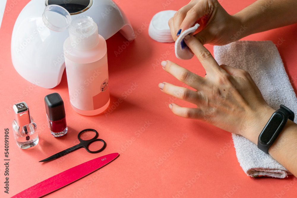 Girl getting a manicure. Taking off the blue nail polish Girl getting a manicure. Taking off the blue nail polish