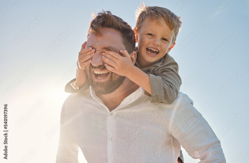 Dad, child and piggy back with covering eyes for game, playing and funny time in sunshine with love. Sun, sky and family with bonding, father and kid while laughing, comic and happy together outdoor Dad, child and piggy back with covering eyes for game, playing and funny time in sunshine with love. Sun, sky and family with bonding, father and kid while laughing, comic and happy together outdoor