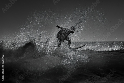 silhouette of surfer on board © Indra