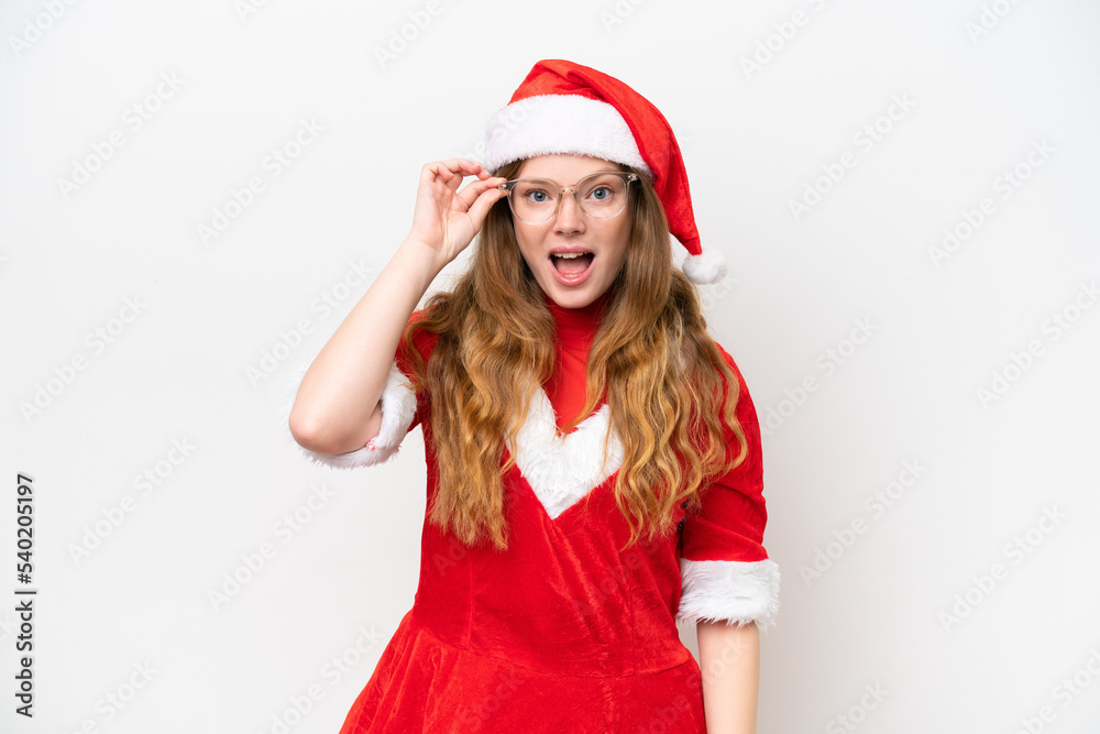 Young caucasian woman with Christmas dress isolated on white background with glasses and surprised Young caucasian woman with Christmas dress isolated on white background with glasses and surprised