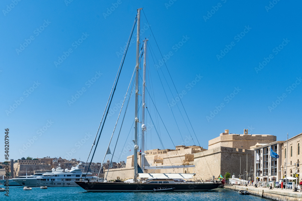 Birgu (Vittoriosa), Malta - September 14th 2022: Sailing yacht moored in Dockyard Creek in front of Fort St. Angelo.