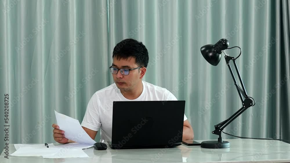technology, remote job and lifestyle concept - happy asian man  man in glasses with laptop computer working at home office or online shopping, home work, freelance, online learning, studying.