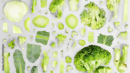 Broccoli vegetable pieces, slices and leaves being moved isolated on white. Seamless looping. High quality 4k video.