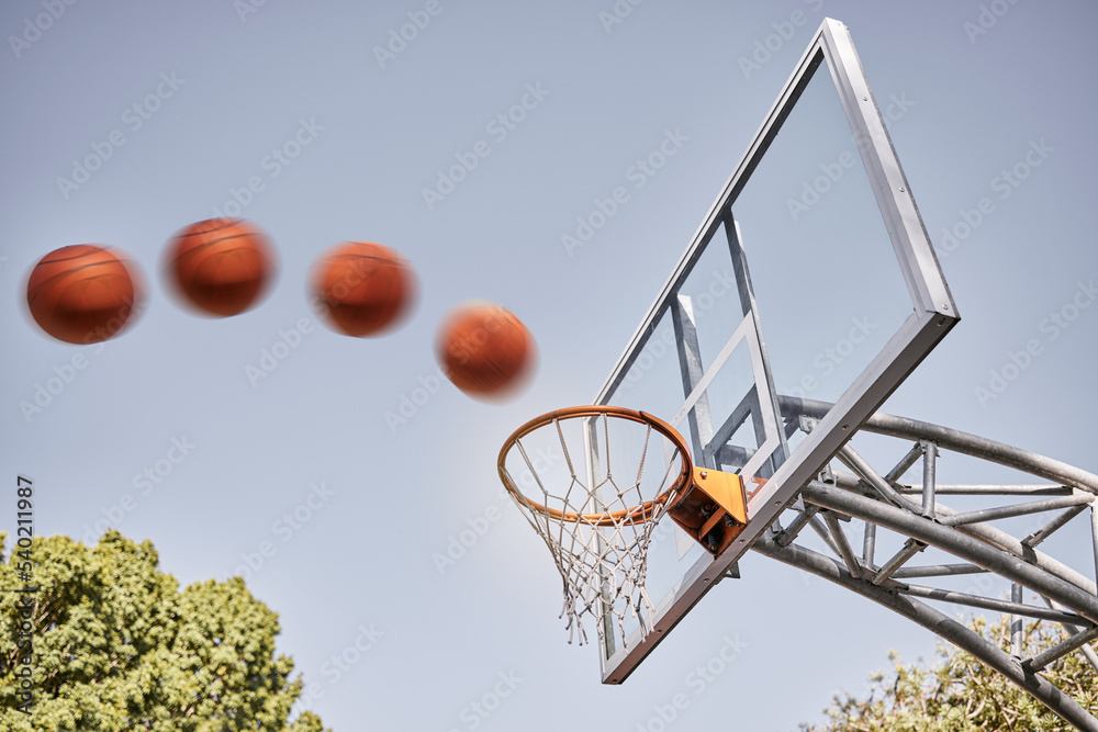 Basketball, point and ball in basket for winning score on basketball court in park with summer sky. Game, sports goals and training practice with motion, action and motivation for winner shot in hoop