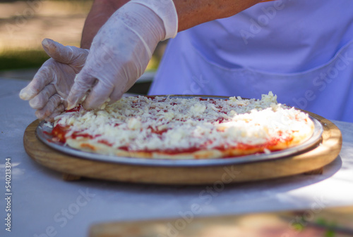 Preparation of italian food outside pizza spagetti and salad