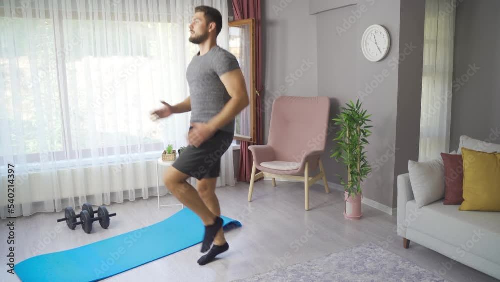 Sporty young man working out legs and body by practicing alone at home.
Active male athlete doing cardio exercises at home.
Sporty young man working out legs and body by practicing alone at home.
Active male athlete doing cardio exercises at home.