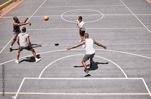 Fitness, sports and friends training on a basketball court with cardio exercise or workout in summer outdoors in Detroit. Healthy, action and young basketball players playing a game or practice match © Beaunitta V W/peopleimages.com