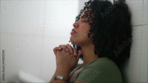 Fotografie One Brazilian young woman in prayer during difficult times
